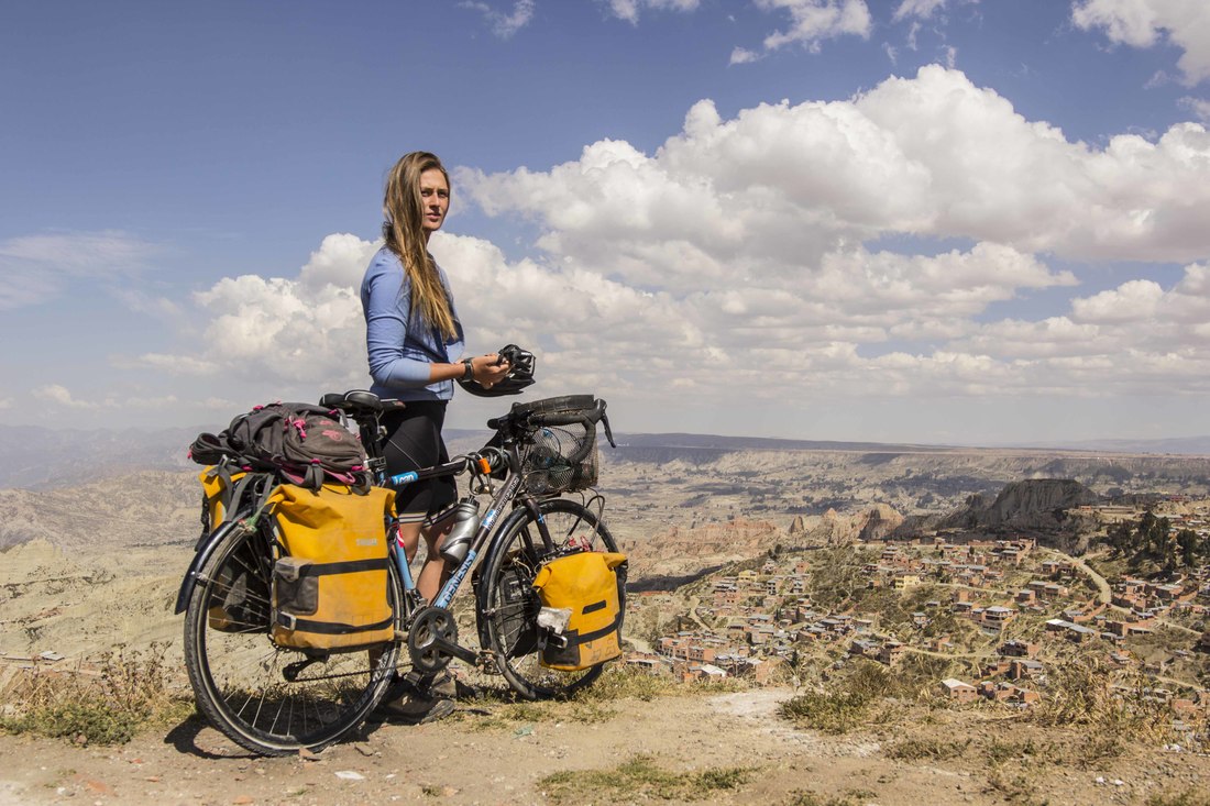 Laura and her loaded touring bike above La Paz, Bolivia