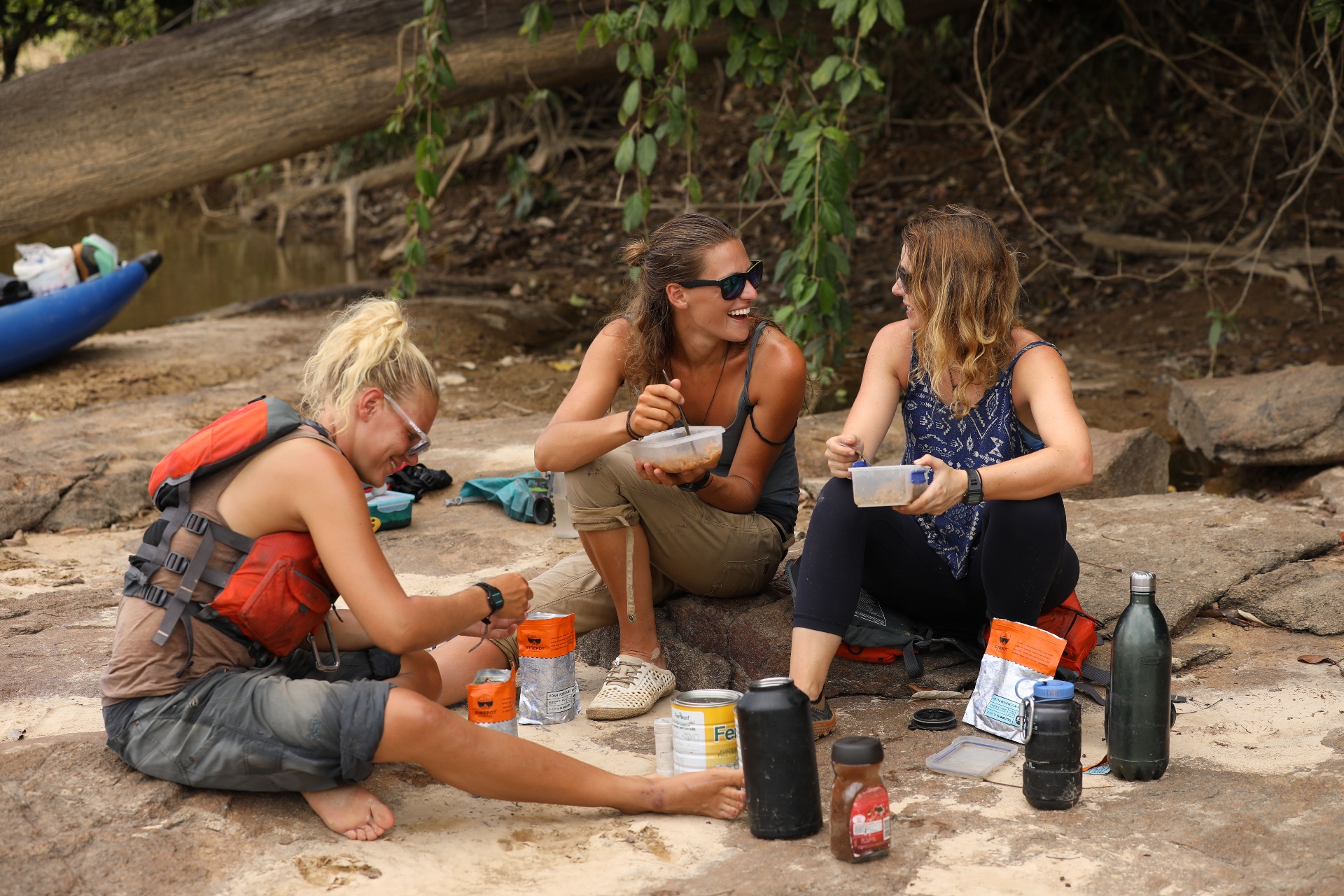 Team resting together on the riverbank during a previous expedition