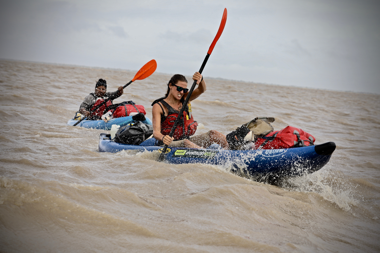 Laura kayaking in rough water during an expedition